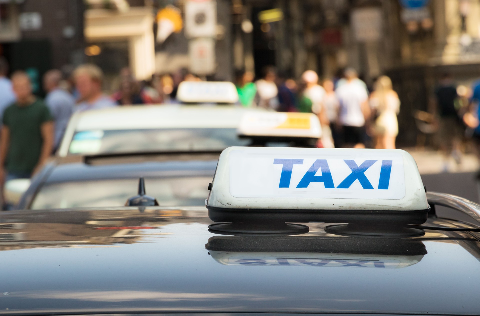 A taxi sign with blue letter on a taxi car in Amsterdam.